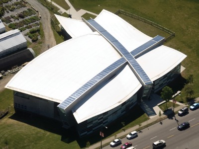 Roofers rolling out a TPO sheet